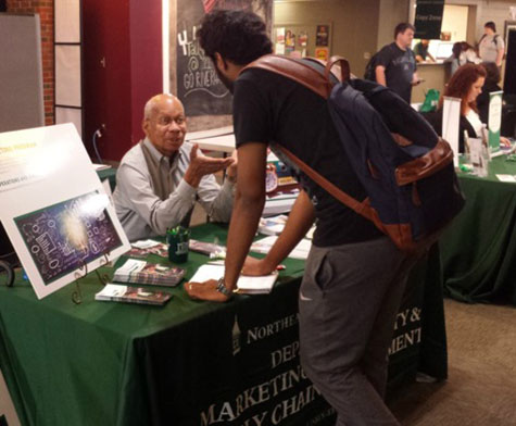 Dr. Ron Petty speaking to a student at the October University Major Fair
