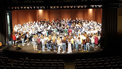 Students on stage for choral workshop