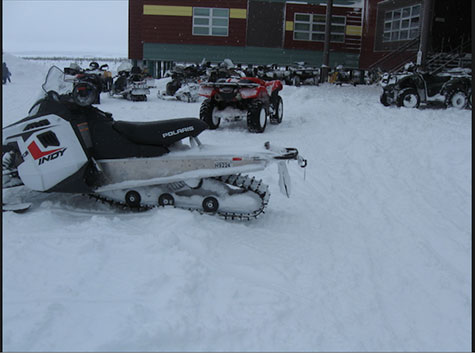 snowmobiles in school parking lot
