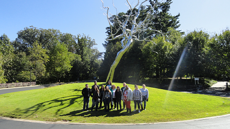TRIO Student Support Services Students posing in front of sculptured metal tree at Crystal Bridges Museum